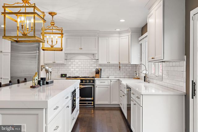 a kitchen with cabinets appliances a sink and a counter top space