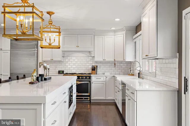a kitchen with cabinets appliances a sink and a counter top space