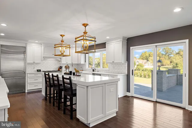 a view of a dining room with furniture a chandelier and wooden floor