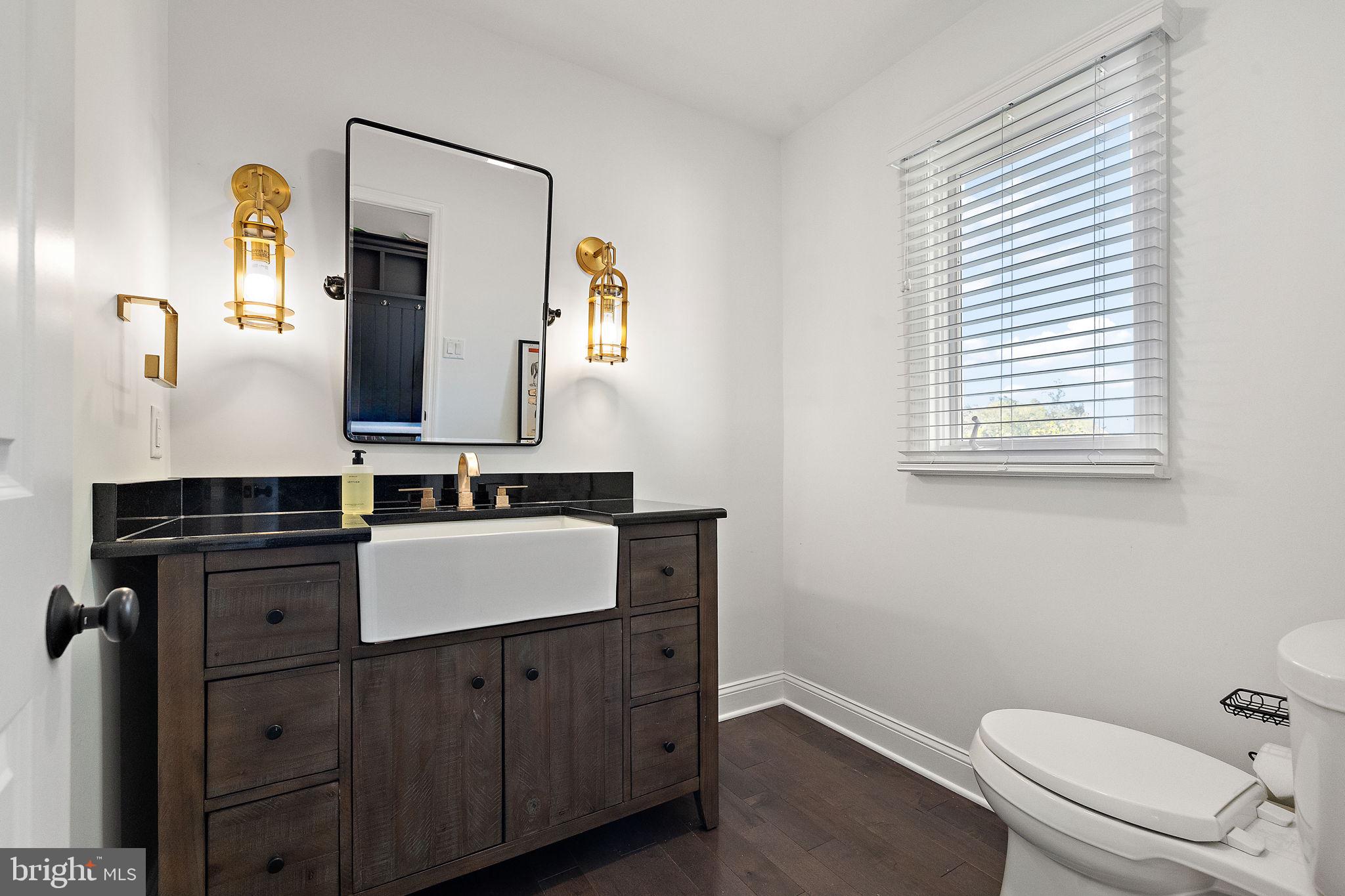 200 Dogwood Slope Road Wilmington, DE 19807 - Photo 32 of 80 a bathroom with a toilet sink and mirror