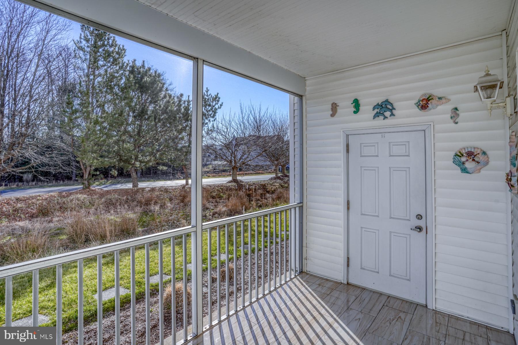 30619 Cedar Neck Road, Unit 1103 Ocean View, DE 19970 - Photo 9 of 58 Screened Porch with views of pond & storage closet