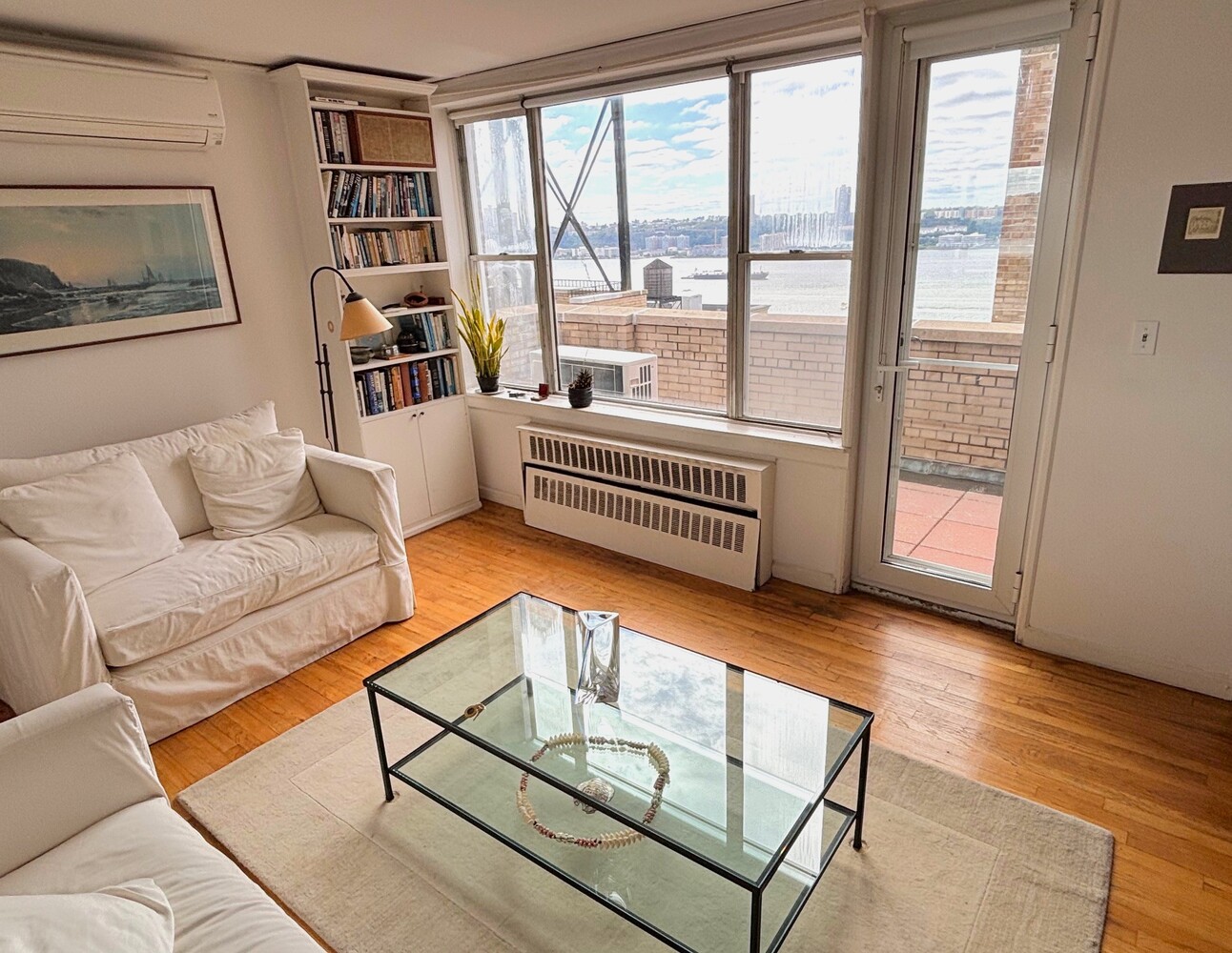 789 West End Avenue, Unit PH6 Manhattan, NY 10025 - Photo 15 of 19 a living room with furniture and a floor to ceiling window