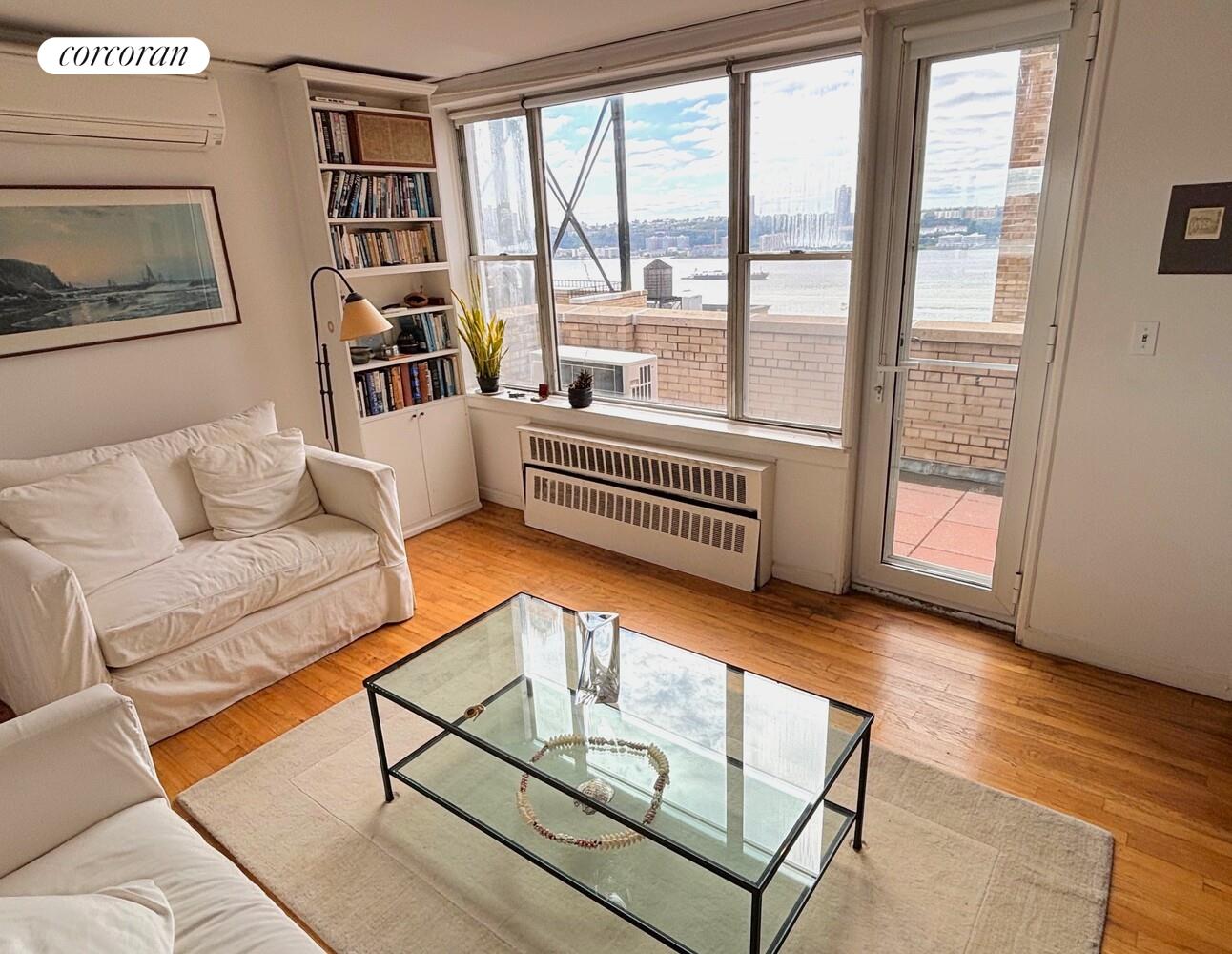 789 West End Avenue, Unit PH6 Manhattan, NY 10025 - Photo 2 of 19 a living room with furniture and a floor to ceiling window