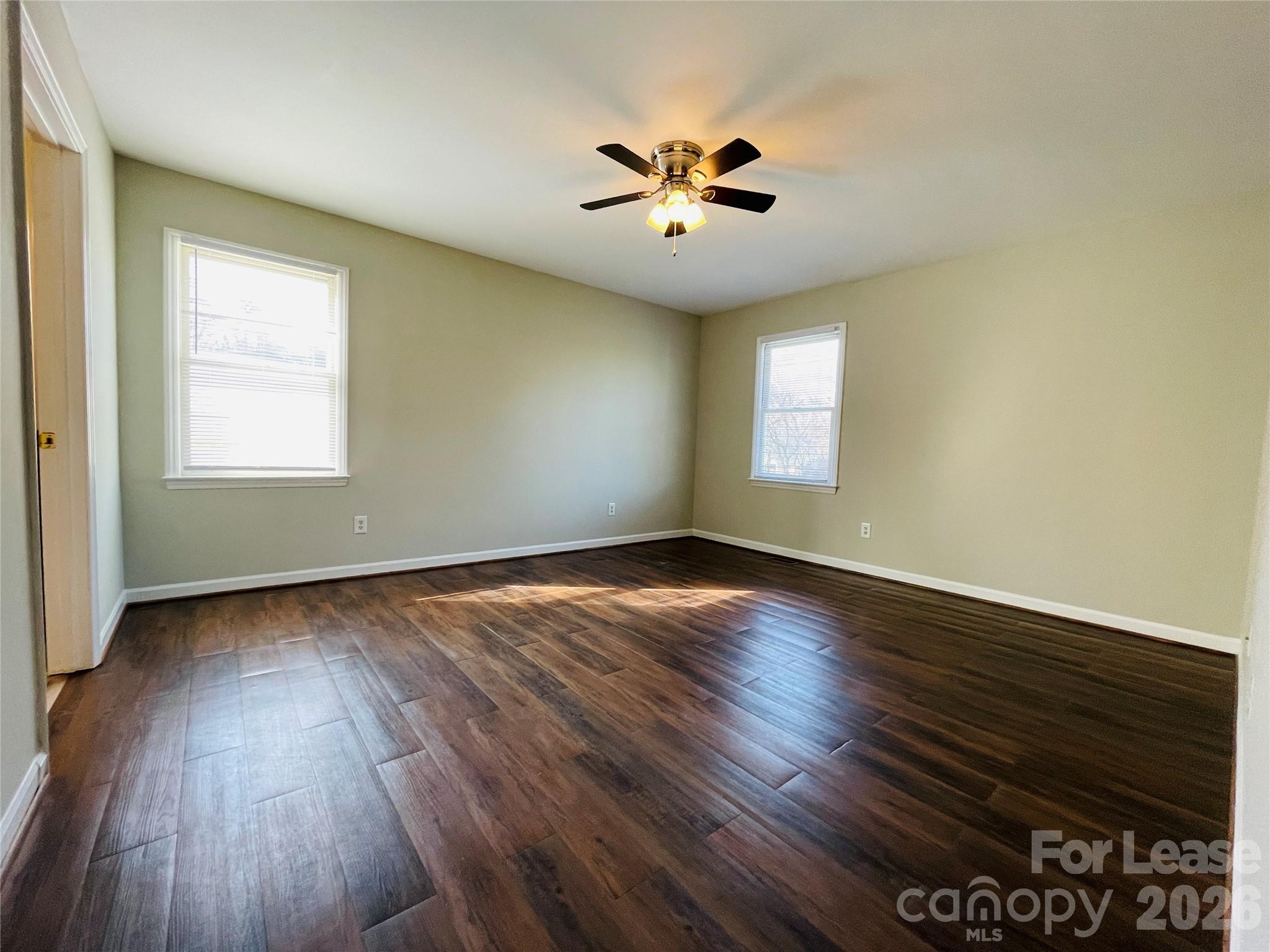 2499 Brookwood Road Lincolnton, NC 28092 - Photo 8 of 12 an empty room with wooden floor and windows