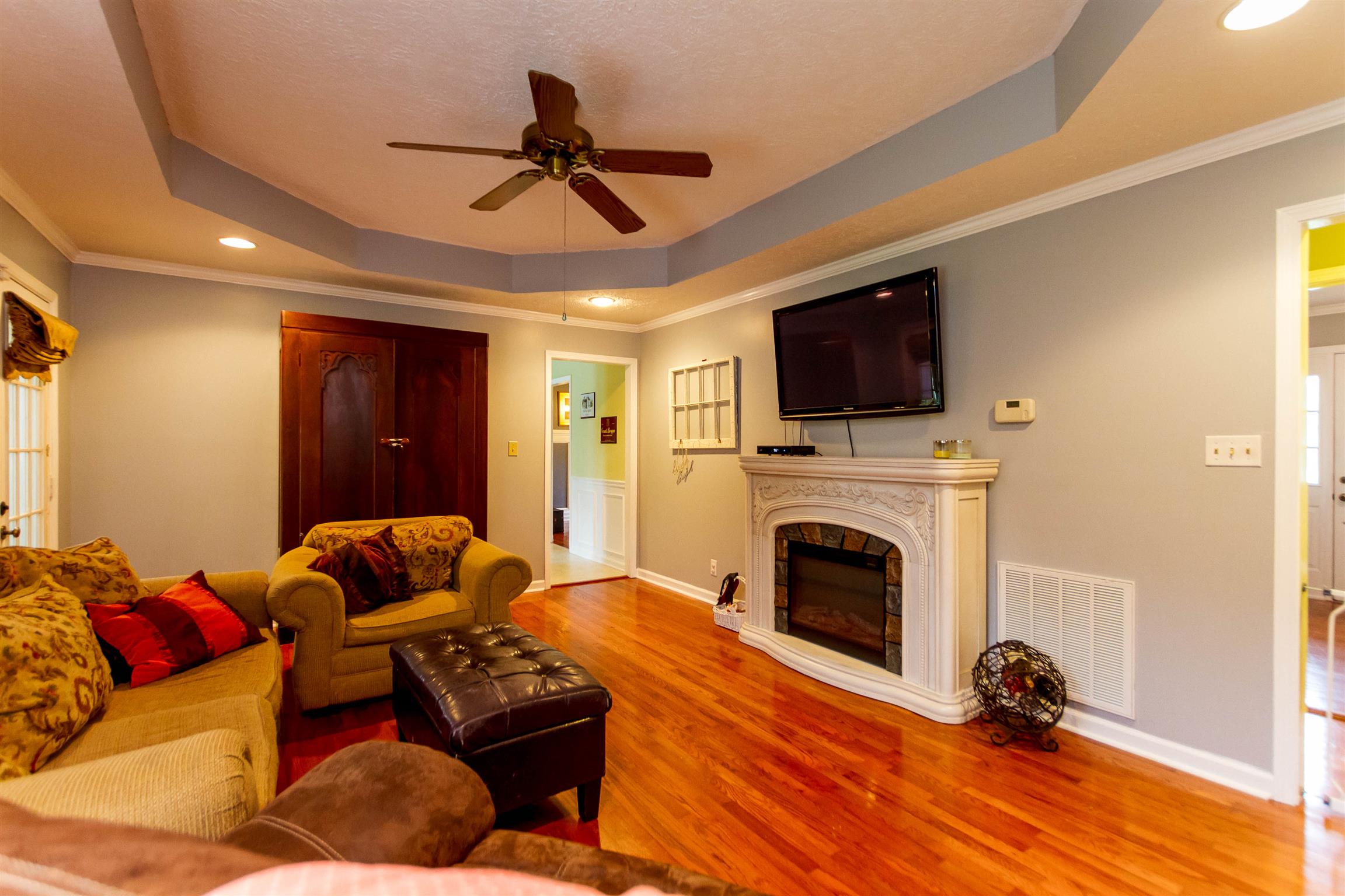 1941 Bradbury Road Adams, TN 37010 - Photo 23 of 30 a living room with furniture a ceiling fan and a flat screen tv
