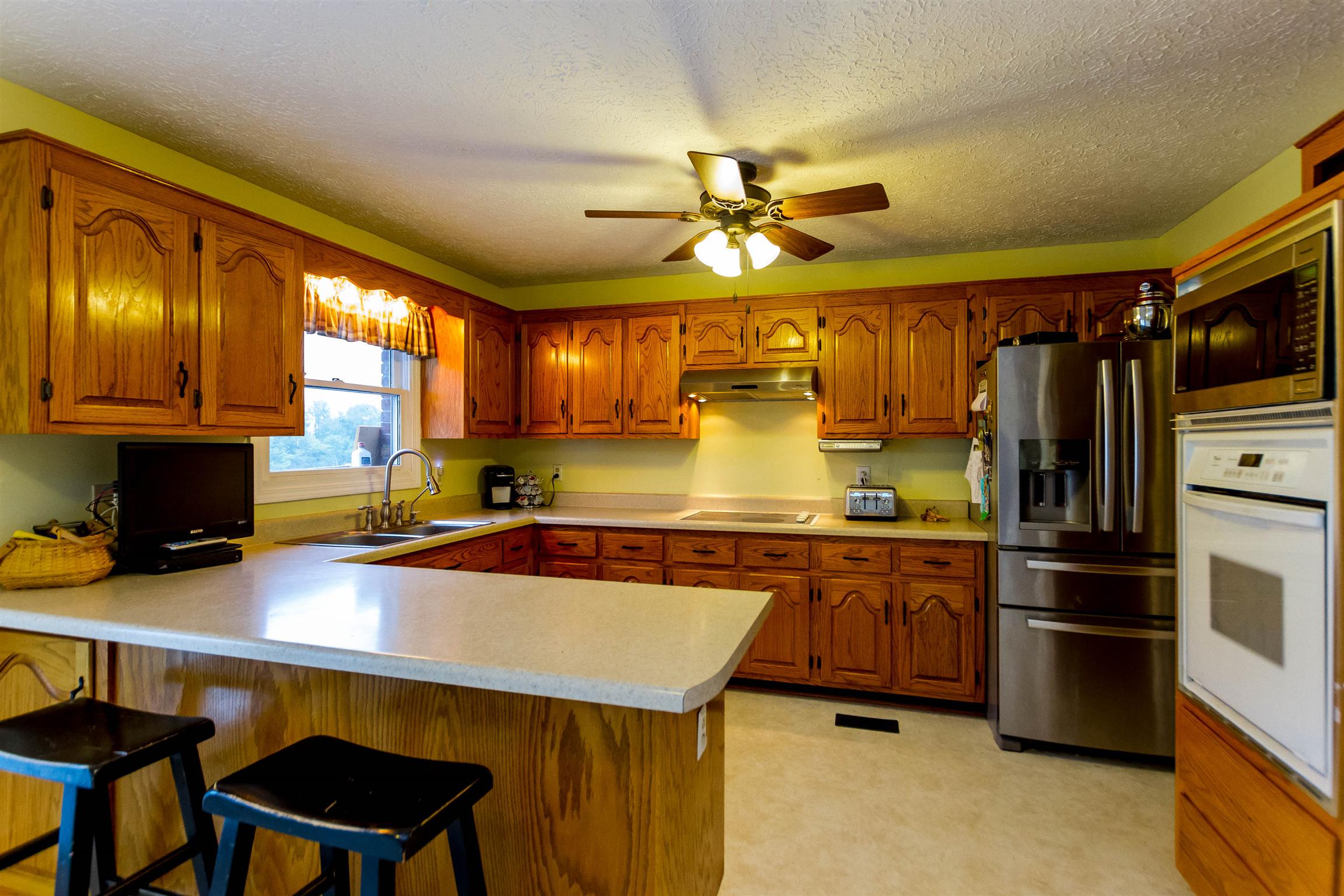 1941 Bradbury Road Adams, TN 37010 - Photo 29 of 30 a kitchen with stainless steel appliances a stove a refrigerator and cabinets