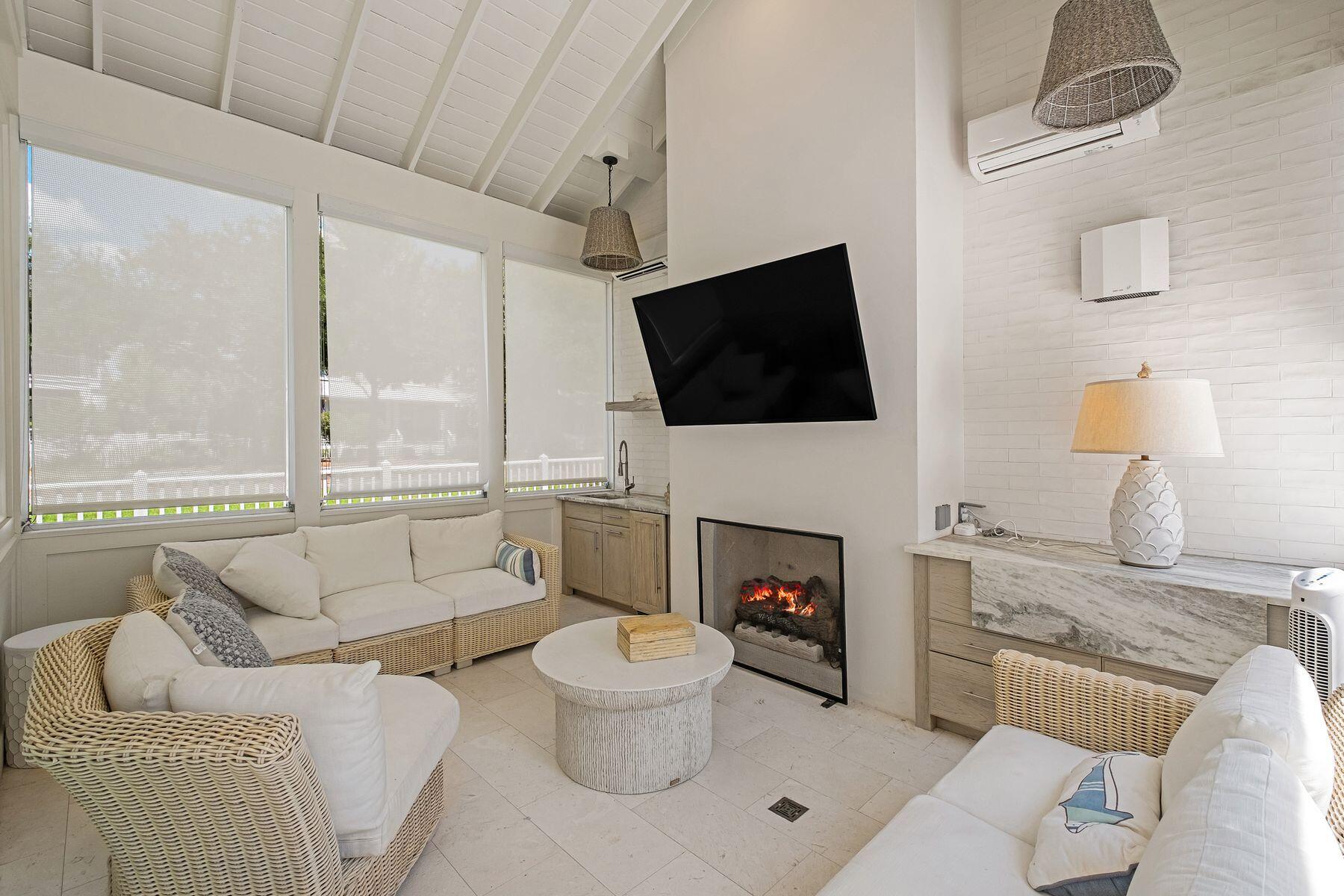 13 Madaket Way Watersound, FL 32461 - Photo 19 of 62 a living room with furniture a fireplace and a flat screen tv