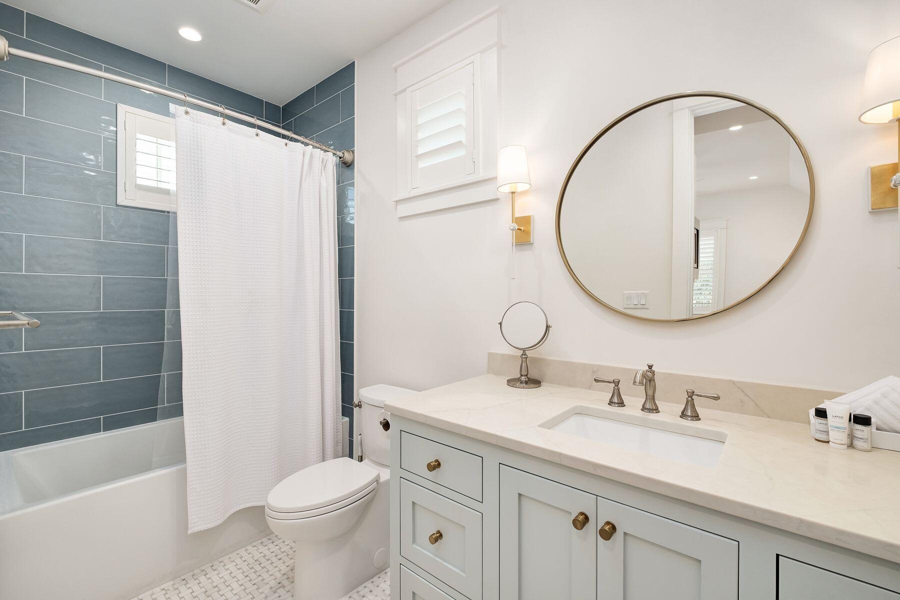 13 Madaket Way Watersound, FL 32461 - Photo 47 of 62 a bathroom with a granite countertop sink toilet and a mirror