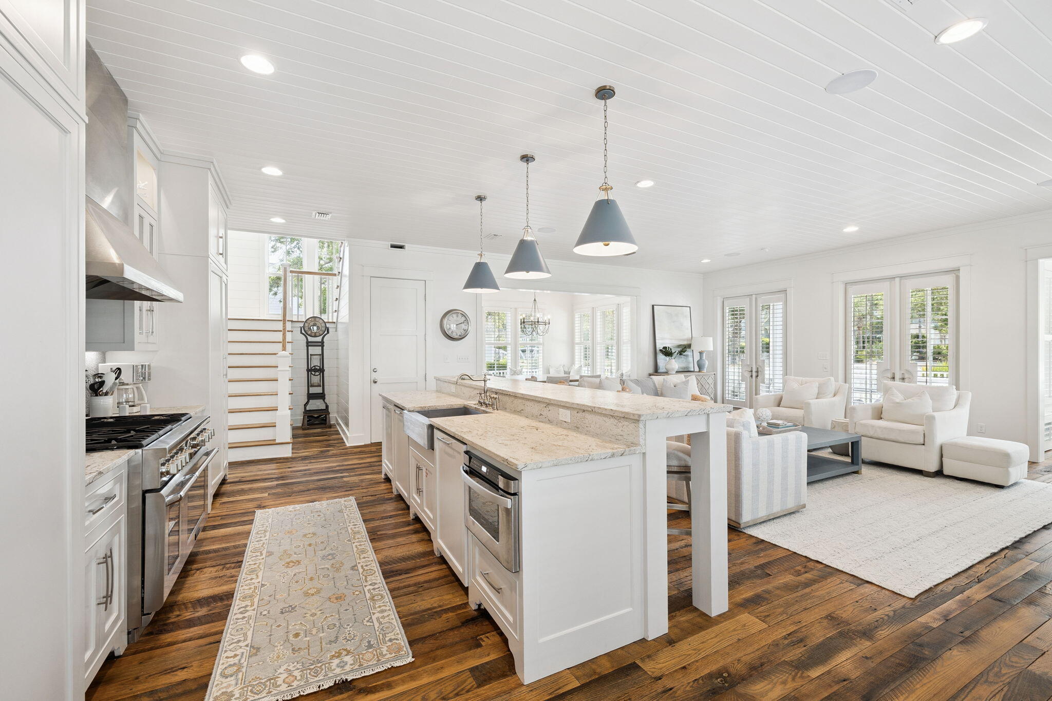 13 Madaket Way Watersound, FL 32461 - Photo 8 of 62 a large kitchen with stainless steel appliances kitchen island granite countertop a large stove a sink dishwasher and a fireplace with wooden floor