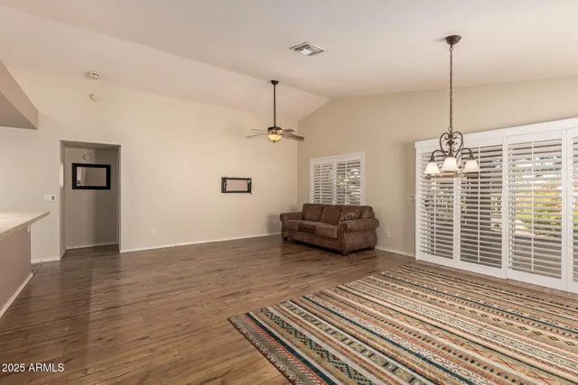 a view of a livingroom with furniture wooden floor and windows