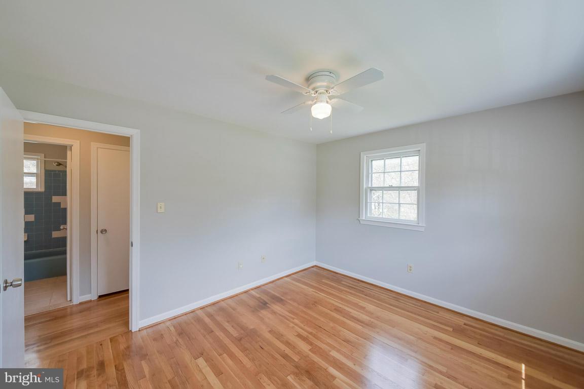 6716 Huntsman Boulevard Springfield, VA 22152 - Photo 12 of 30 a view of empty room with wooden floor and fan