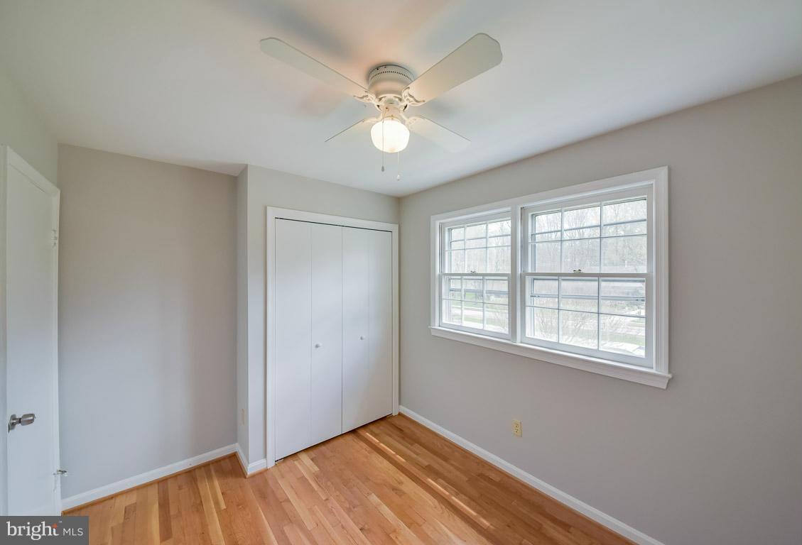6716 Huntsman Boulevard Springfield, VA 22152 - Photo 16 of 30 wooden floor in an empty room with a window