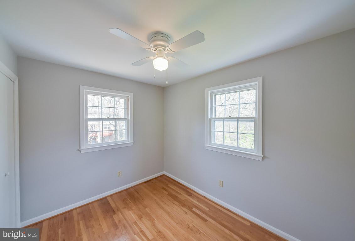 6716 Huntsman Boulevard Springfield, VA 22152 - Photo 19 of 30 wooden floor in an empty room with a window