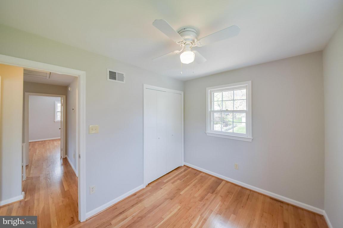 6716 Huntsman Boulevard Springfield, VA 22152 - Photo 20 of 30 a view of an empty room with wooden floor and a window