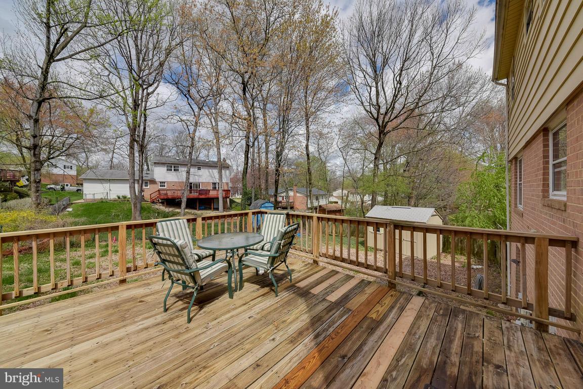 6716 Huntsman Boulevard Springfield, VA 22152 - Photo 27 of 30 a view of balcony with wooden floor and outdoor seating