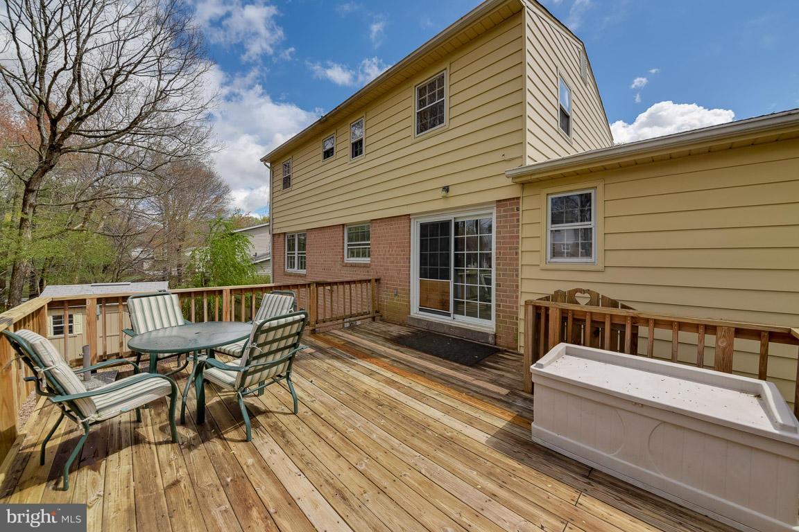 6716 Huntsman Boulevard Springfield, VA 22152 - Photo 28 of 30 a balcony with wooden floor table and chairs