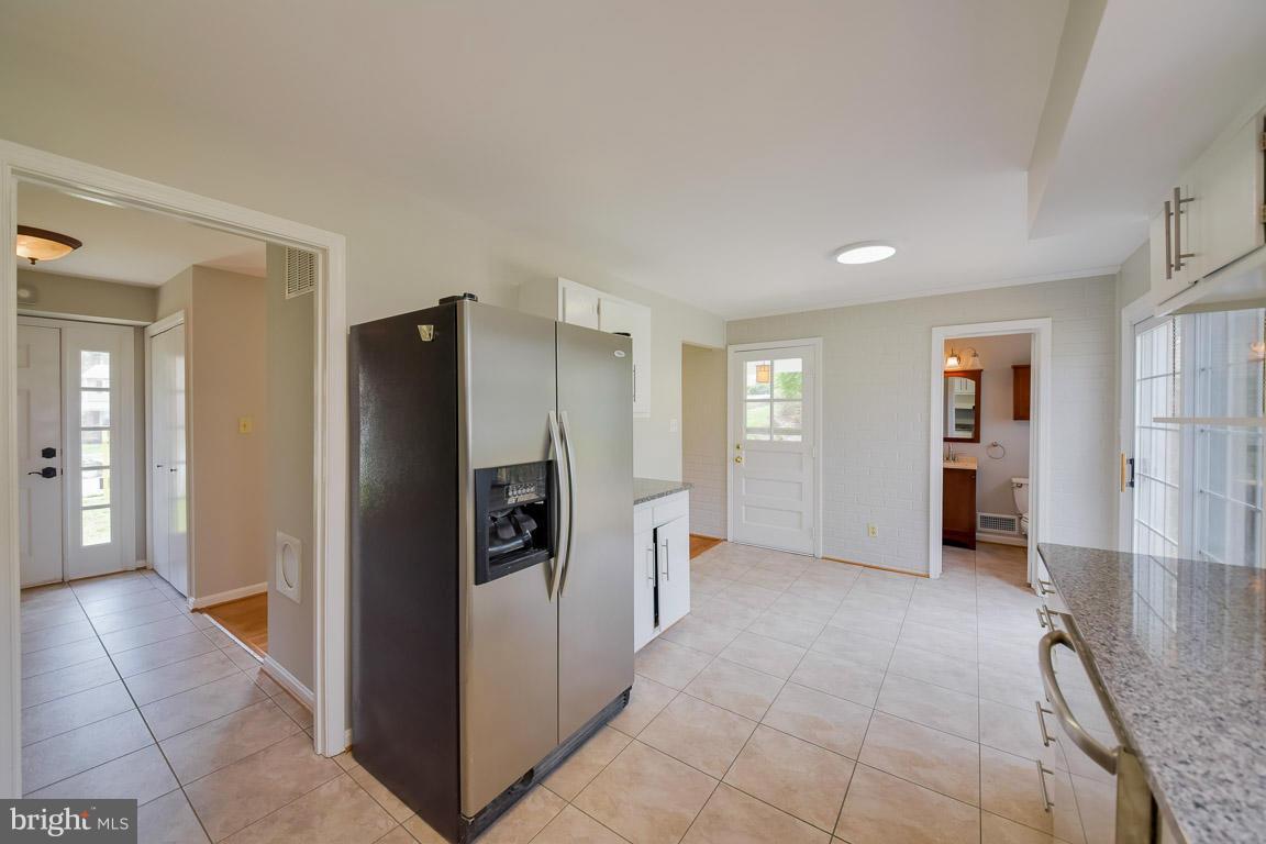 6716 Huntsman Boulevard Springfield, VA 22152 - Photo 6 of 30 a view of a kitchen with refrigerator and an empty room