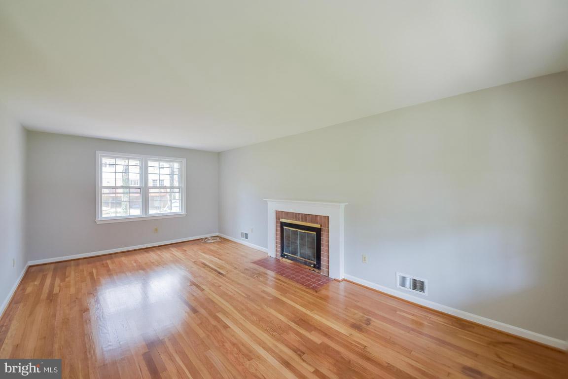 6716 Huntsman Boulevard Springfield, VA 22152 - Photo 7 of 30 an empty room with wooden floor and windows