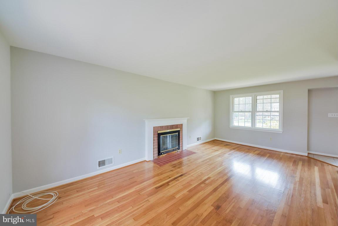 6716 Huntsman Boulevard Springfield, VA 22152 - Photo 8 of 30 a view of empty room with wooden floor and fan