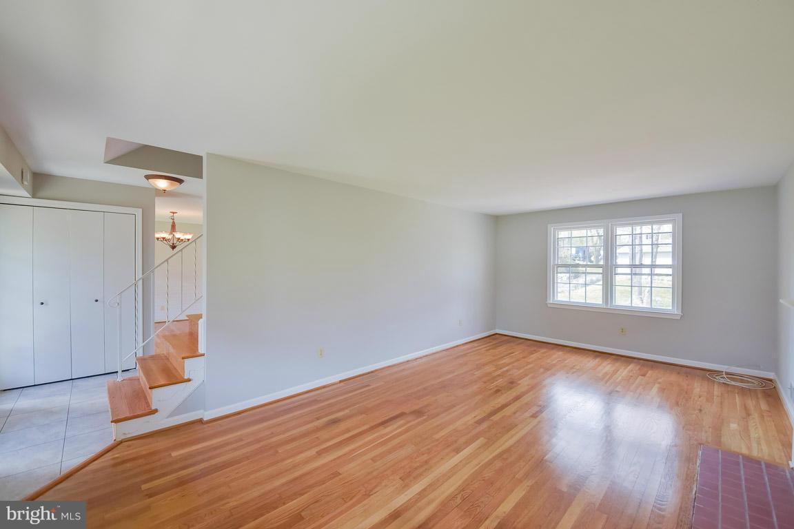 6716 Huntsman Boulevard Springfield, VA 22152 - Photo 9 of 30 an empty room with wooden floor and windows