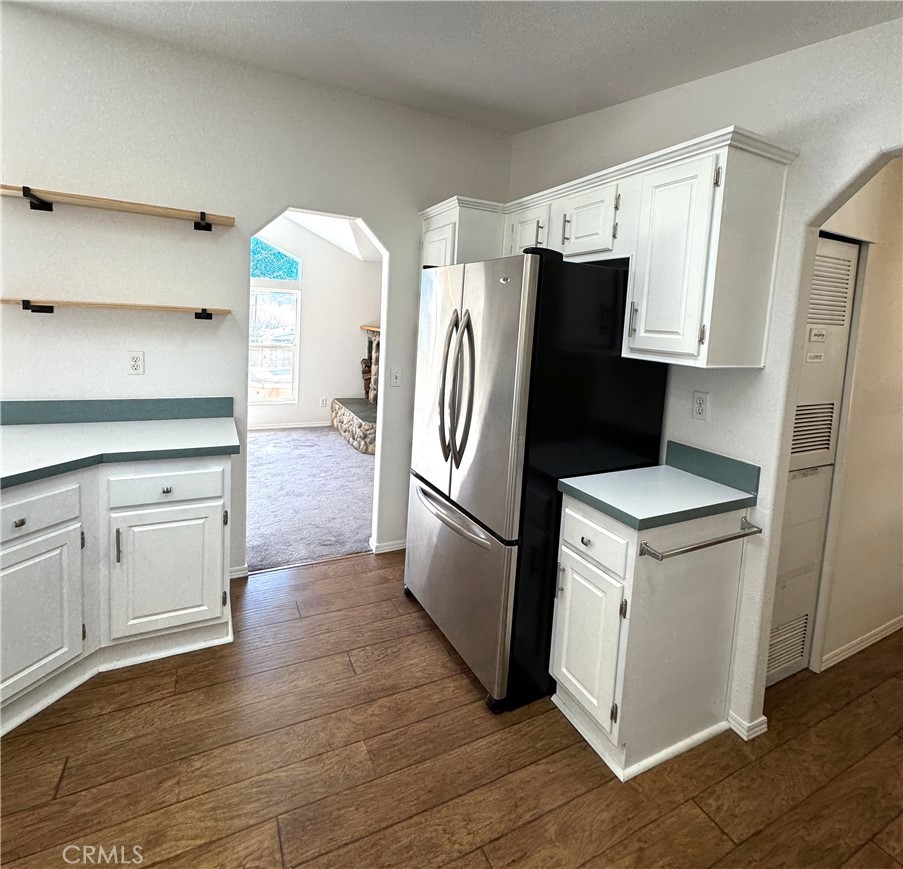 4190 Hackney Way Paso Robles, CA 93446 - Photo 12 of 40 a kitchen with stainless steel appliances a refrigerator a stove a sink and white cabinets with wooden floor