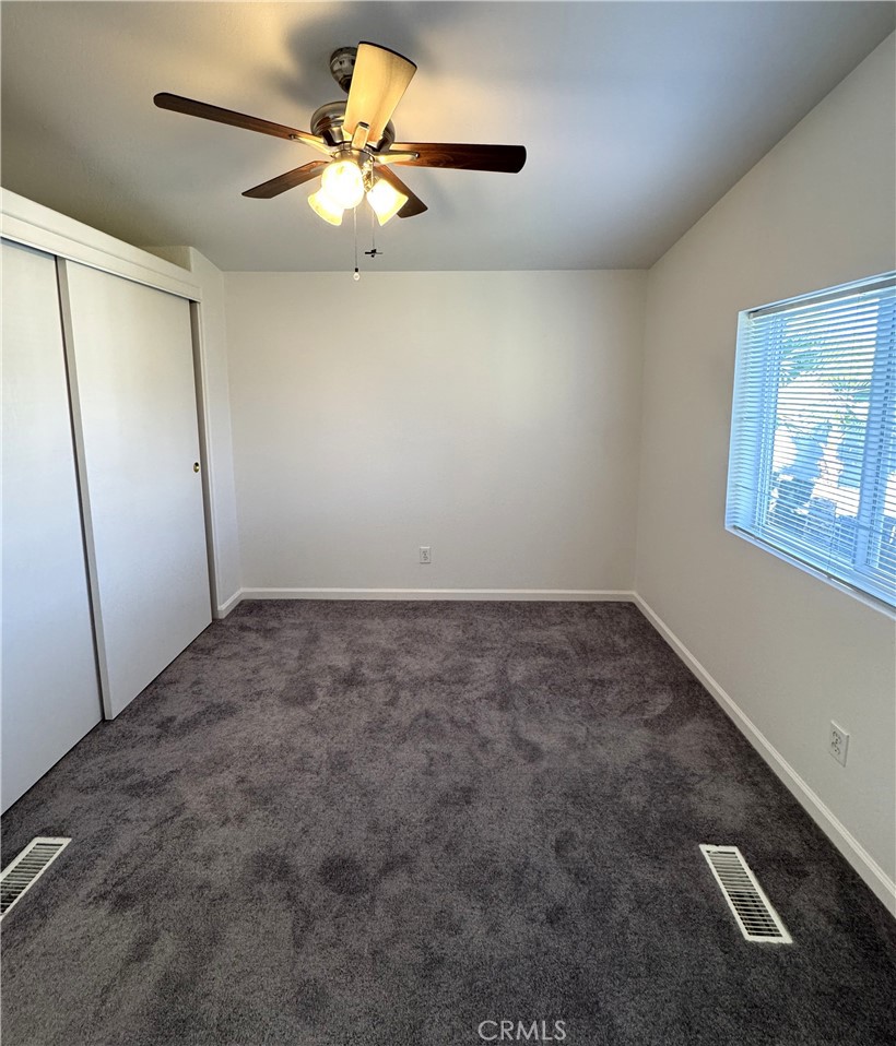 4190 Hackney Way Paso Robles, CA 93446 - Photo 30 of 40 an empty room with a chandelier fan and windows