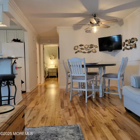 a dinning room with furniture and wooden floor