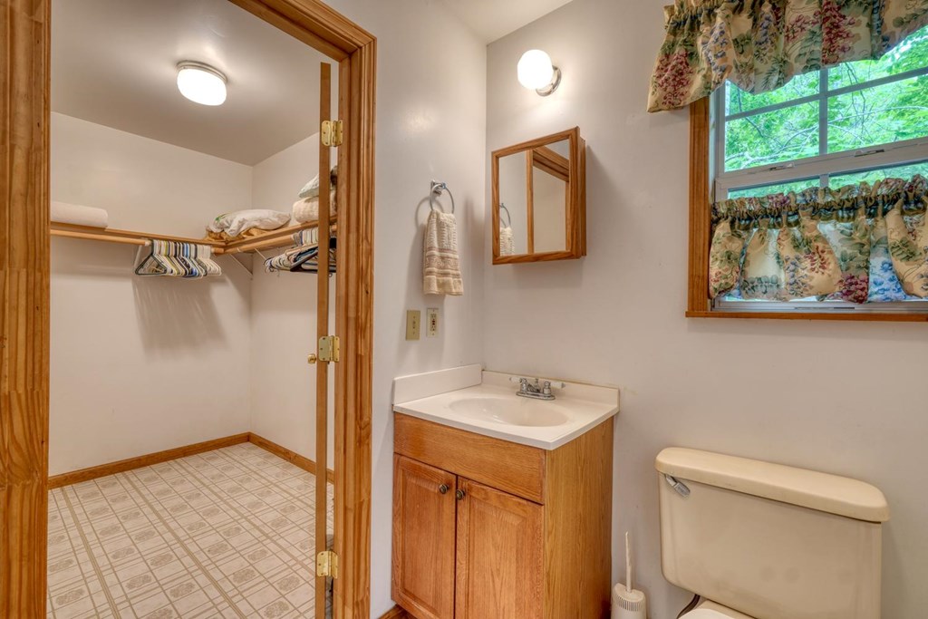 1066 Ridge Road Hiawassee, GA 30546 - Photo 43 of 51 a bathroom with a sink a toilet and a mirror