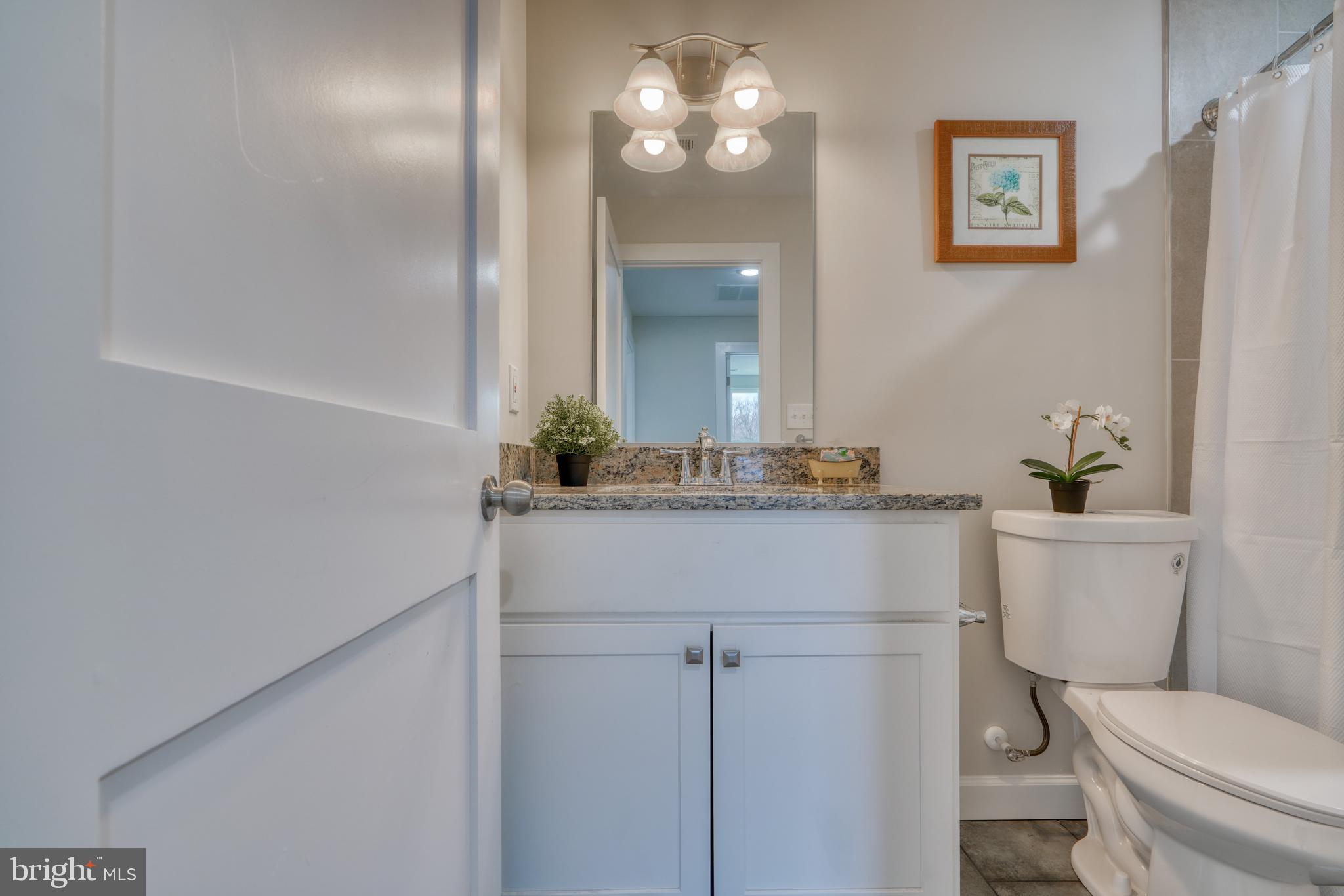 231 Mallow Hill Road Baltimore, MD 21229 - Photo 35 of 48 a bathroom with a toilet sink and mirror