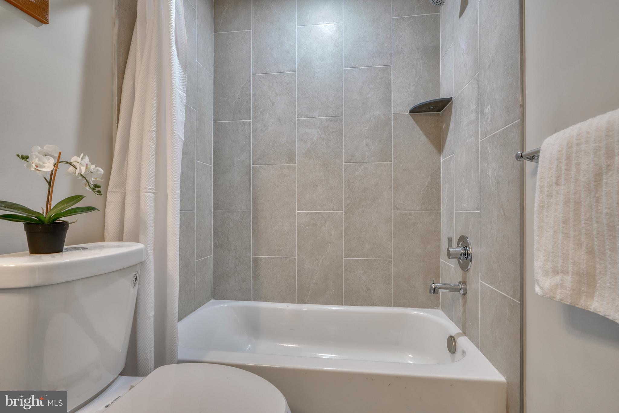 231 Mallow Hill Road Baltimore, MD 21229 - Photo 36 of 48 a white bath tub sitting next to a white toilet