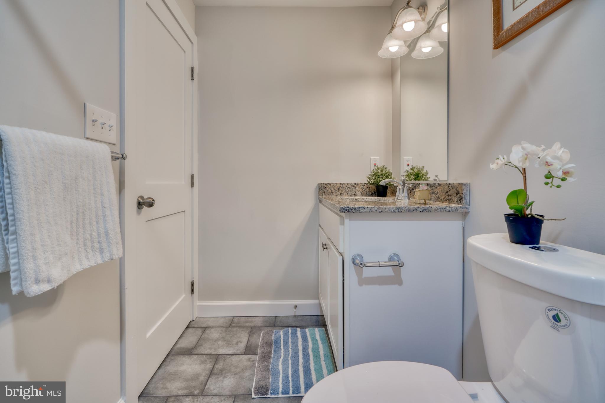 231 Mallow Hill Road Baltimore, MD 21229 - Photo 37 of 48 a bathroom with a sink a toilet and shower