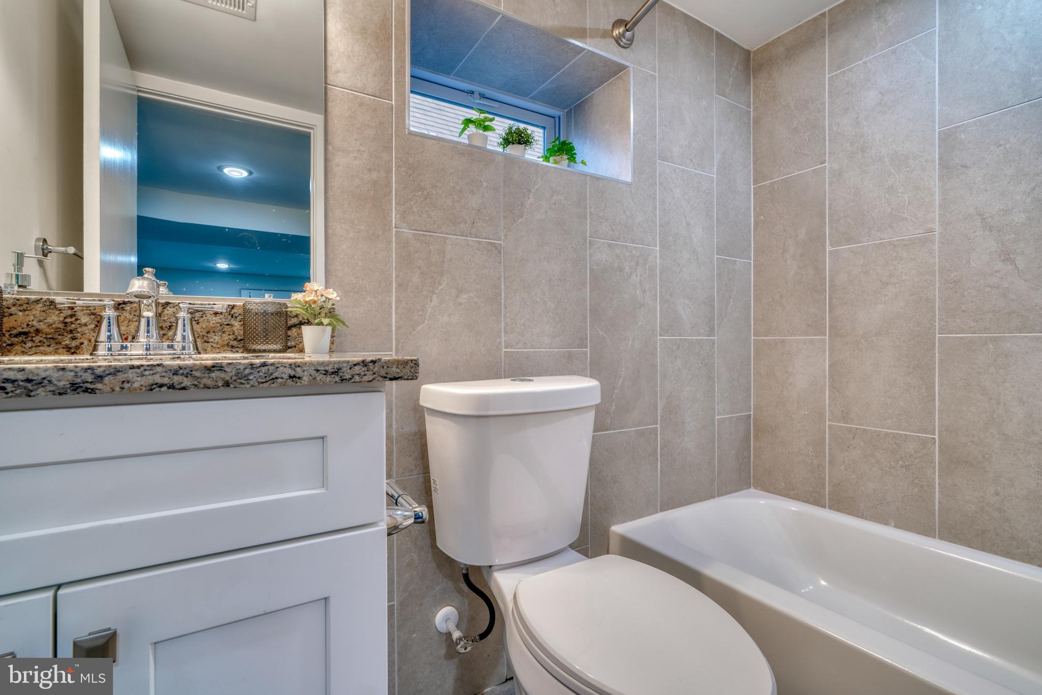 231 Mallow Hill Road Baltimore, MD 21229 - Photo 44 of 48 a bathroom with a granite countertop toilet sink and mirror