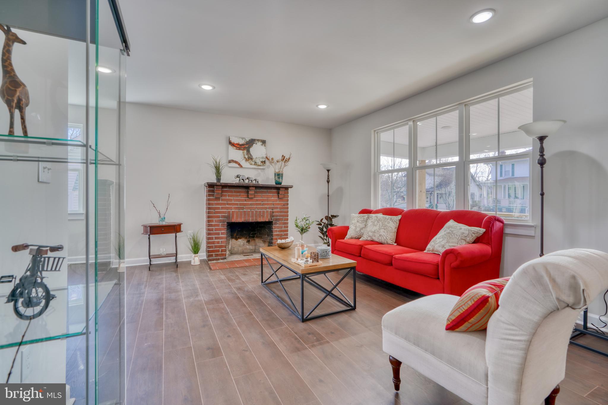 231 Mallow Hill Road Baltimore, MD 21229 - Photo 10 of 48 a living room with furniture and a fireplace