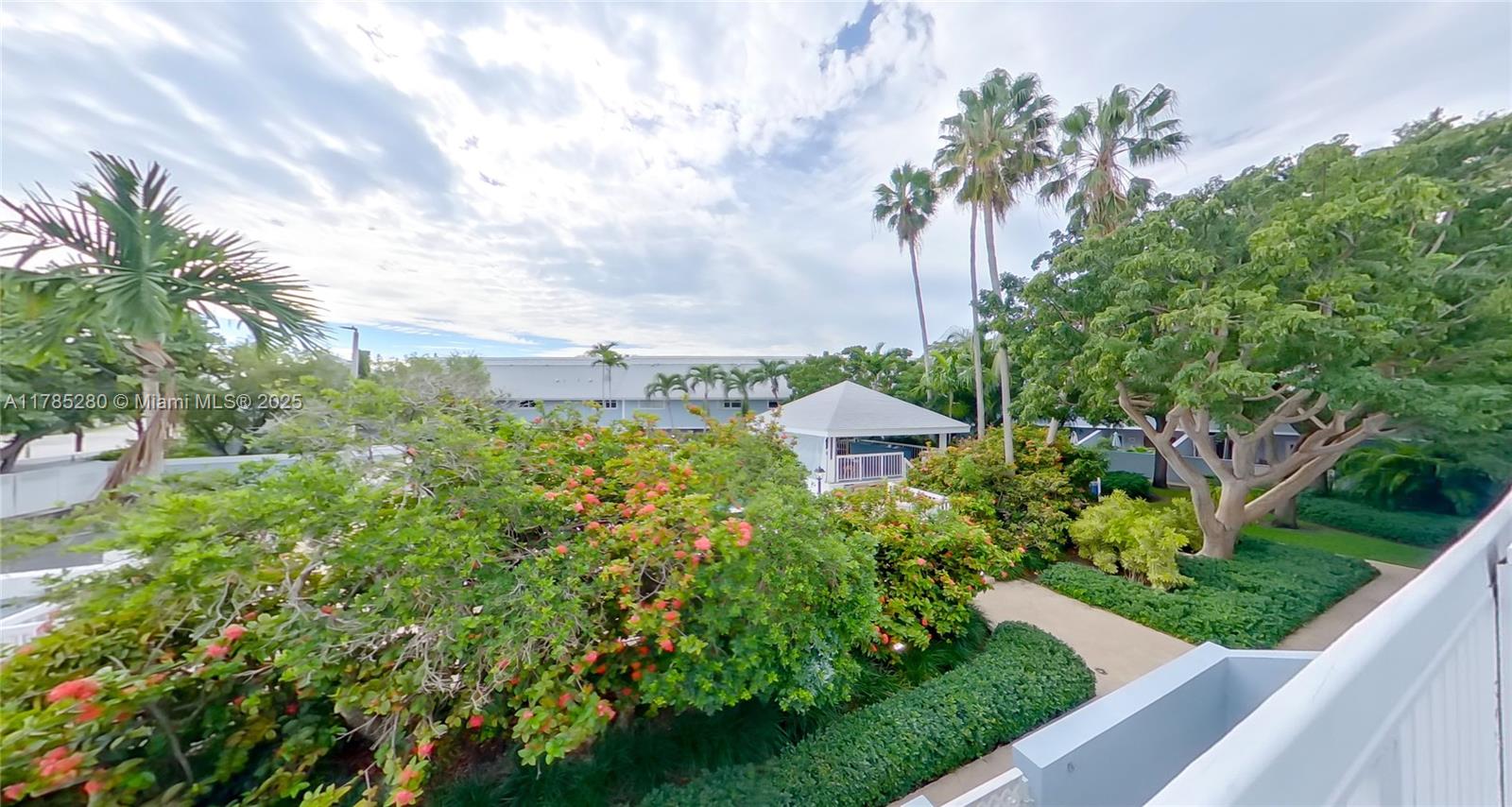 798 Crandon Boulevard, Unit 45B Key Biscayne, FL 33149 - Photo 15 of 22 a view of a house with a yard and potted plants
