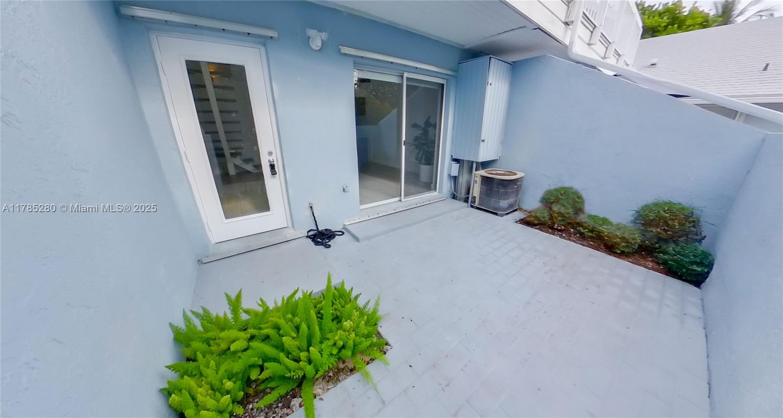 798 Crandon Boulevard, Unit 45B Key Biscayne, FL 33149 - Photo 18 of 22 front view of a house with a potted plant