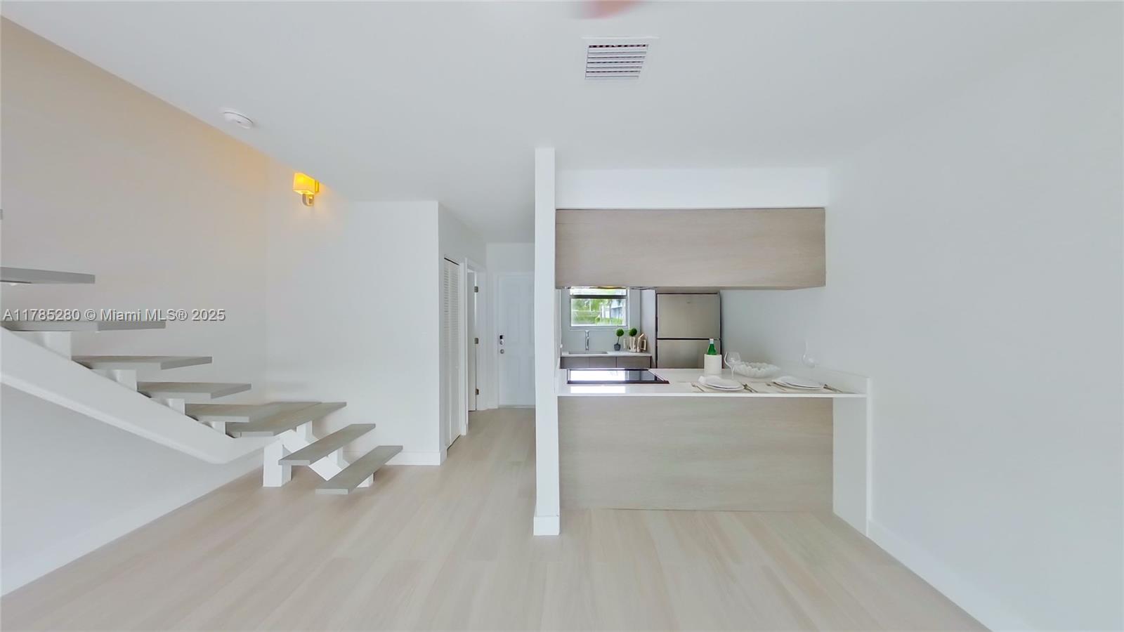 798 Crandon Boulevard, Unit 45B Key Biscayne, FL 33149 - Photo 2 of 22 a very nice looking room with a large window and a table