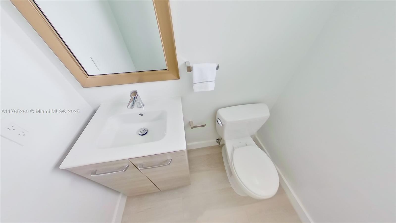 798 Crandon Boulevard, Unit 45B Key Biscayne, FL 33149 - Photo 7 of 22 a bathroom with a toilet sink and mirror