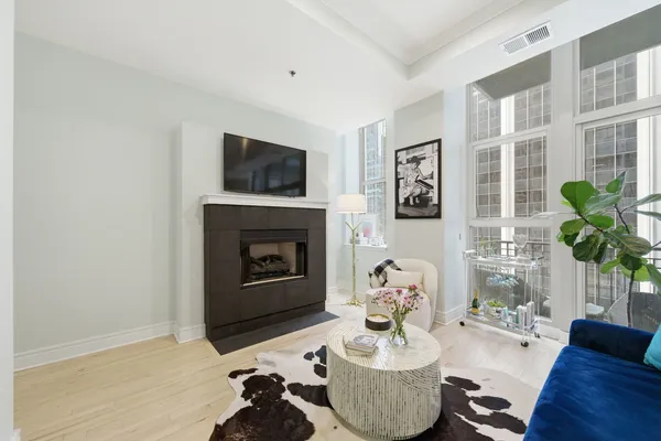a living room with furniture a fireplace and a flat screen tv