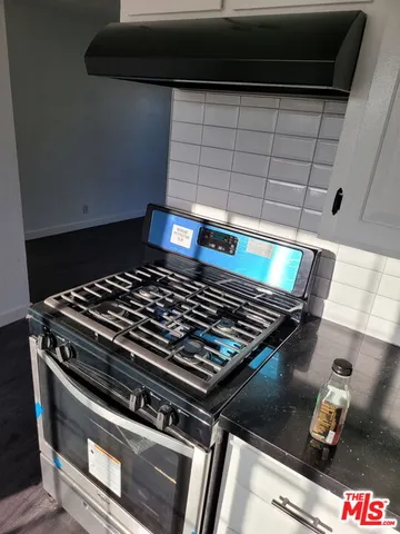 a stove top oven sitting inside of a kitchen