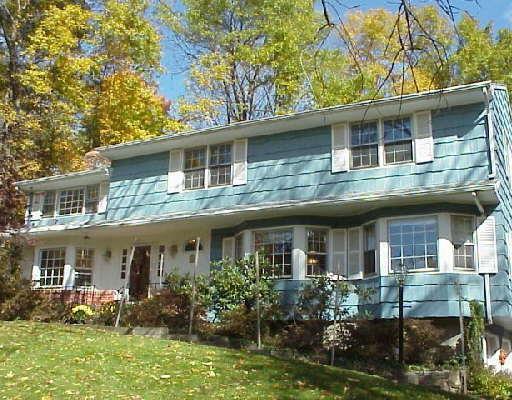 84 Remington Road Ridgefield, CT 06877 - Photo 1 of 1 a front view of a house with garden