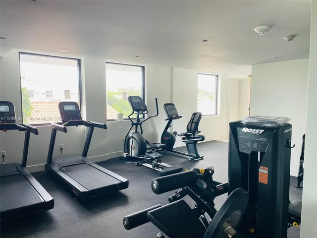 a room with gym equipment and a large window