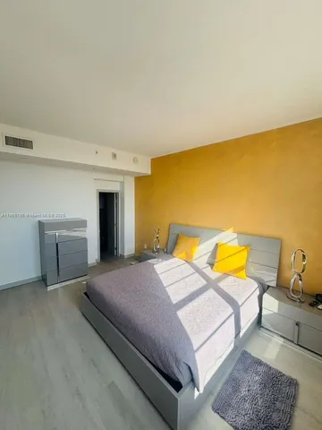 a bedroom with a bed and a couch