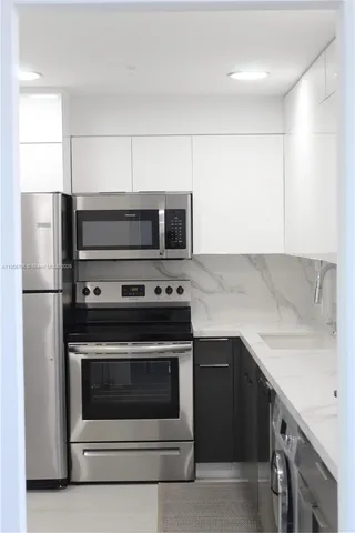 a kitchen with a stove microwave and refrigerator