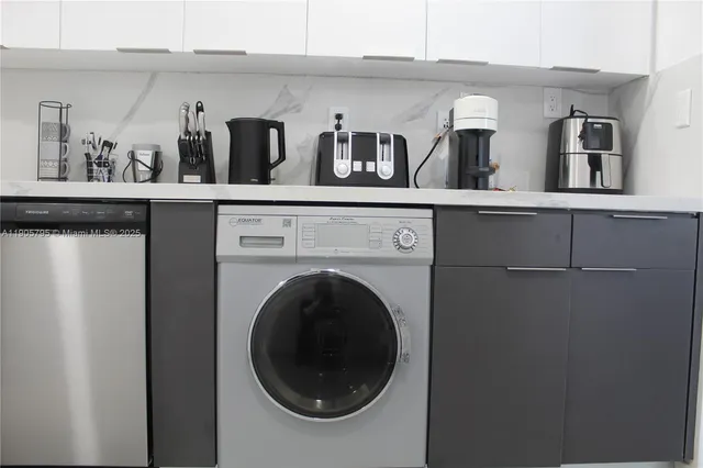 a view of a living room with washer and dryer