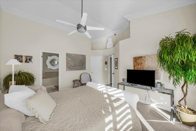 150 South Crystal Street, Unit 31 St. George, UT 84770 - Photo 14 of 20 Carpeted bedroom featuring ornamental molding, a high ceiling, connected bathroom, and a ceiling fan
