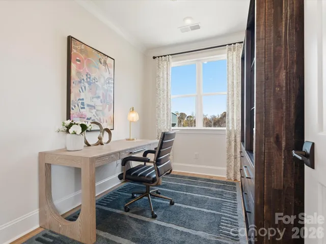 a workspace with wooden floor and a window