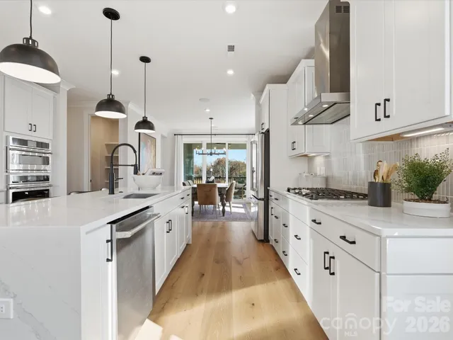 a large kitchen with stainless steel appliances lots of counter space sink and cabinets