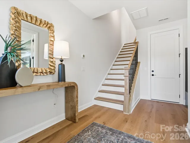 a view of entryway and hall with wooden floor