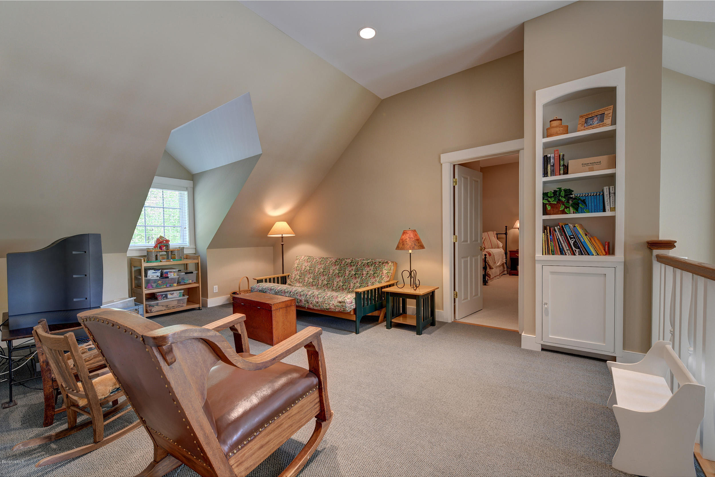 28 Austerlitz Road West Stockbridge, MA 01266 - Photo 26 of 44 a living room with furniture and a book shelf