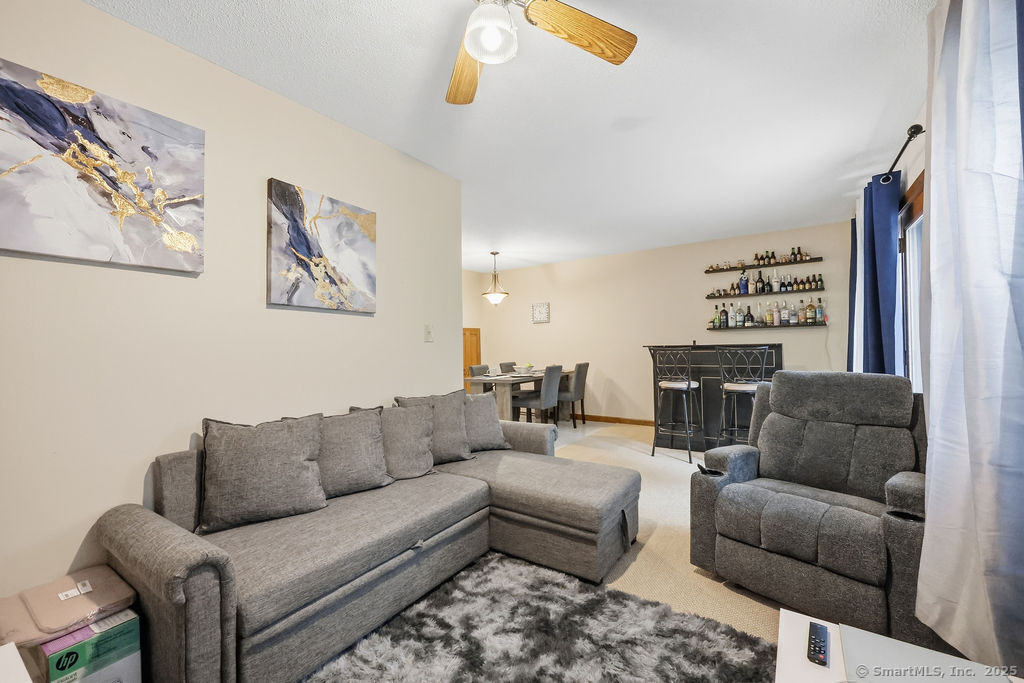 25 Washington Street, Unit 20 Bristol, CT 06010 - Photo 14 of 29 a living room with furniture a couch and a view of kitchen
